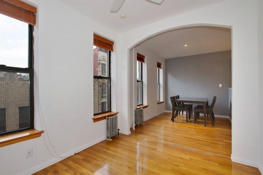 Sun flooded West Village 1 bedroom with Empire State Building views, featuring a recently renovated kitchen, white tile bath, and a generous living dining space.