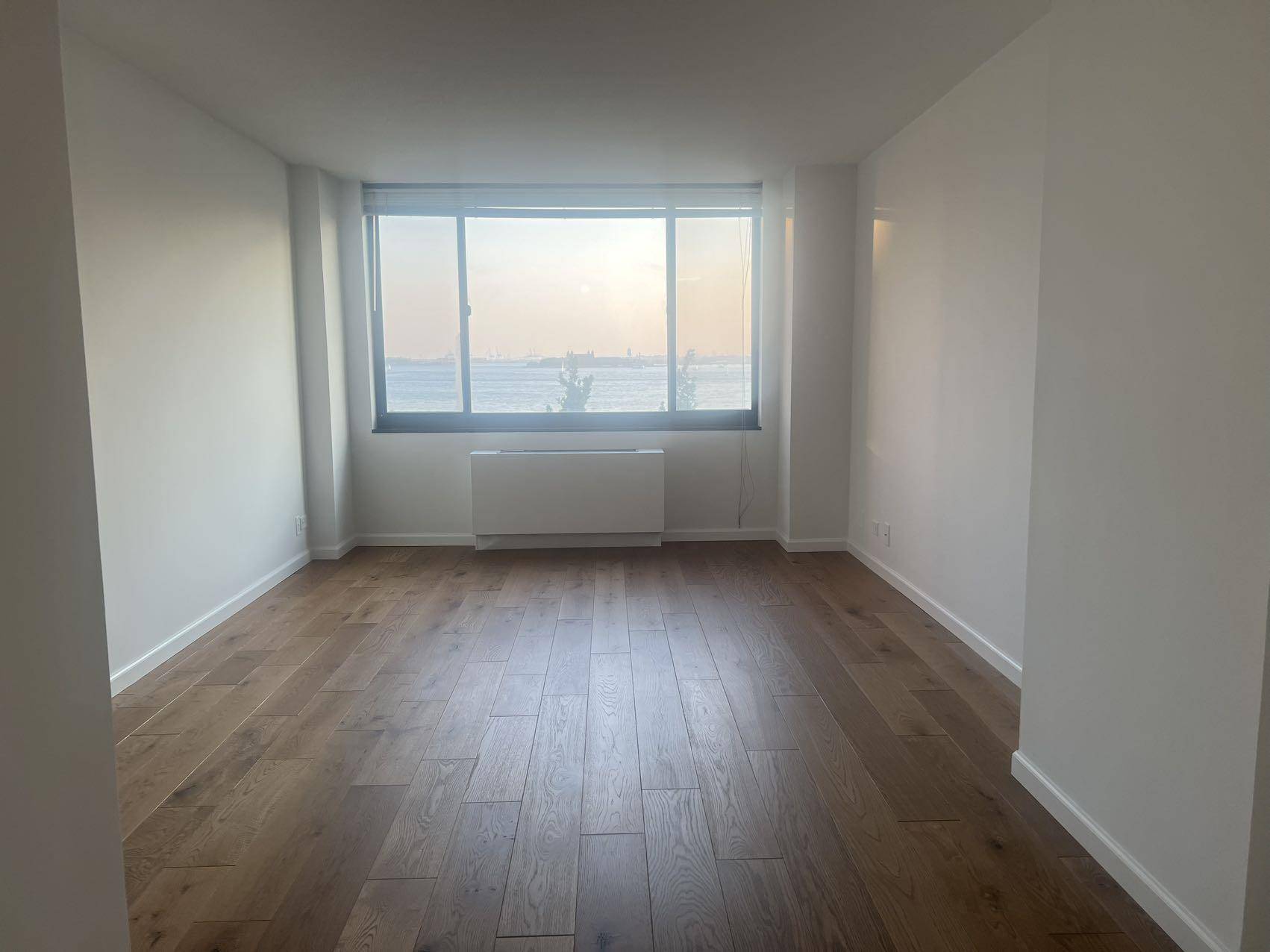 This renovated west facing 1BR 1BA residence features a generously proportioned living space with direct river and Statue of liberty views.