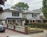 Traditional style home featuring roof mounted solar panels, covered porch, and driveway