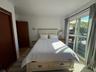Bedroom with access to exterior and light wood-type flooring