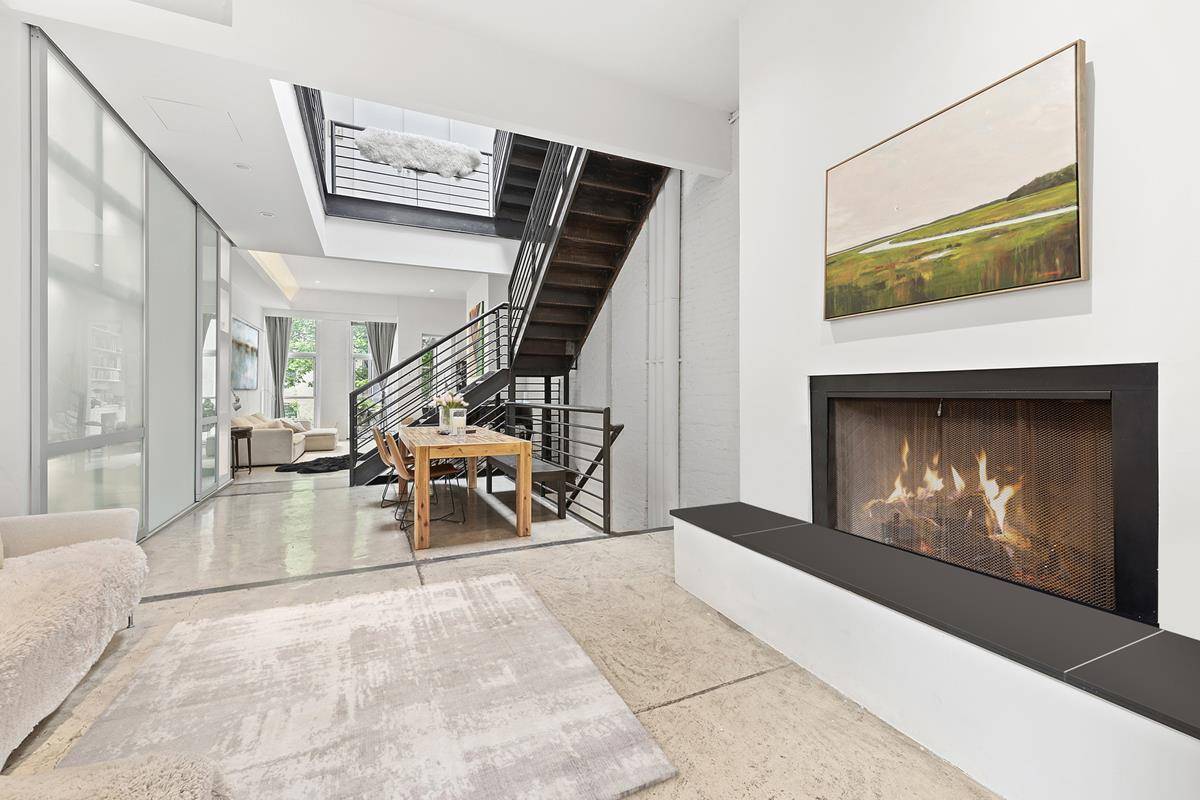 TRIBECA MEETS HARLEM ! ! One of a kind custom renovated townhouse with dramatic skylight embracing the entire space radiant heated floors, unique metal staircase and four wood burning fireplaces.