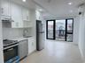 Kitchen with appliances with stainless steel finishes, white cabinets, recessed lighting, light stone countertops, and a wall mounted AC
