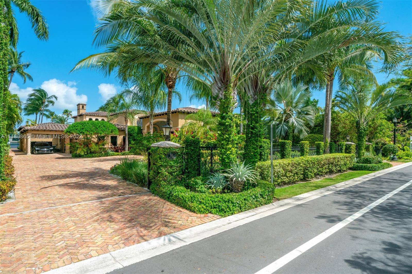 Very special Mediterranean waterfront estate on exclusive, guard gated Palm Island w 100 ft of water frontage, floating dock, 2 boat slips w lifts no bridges to the ocean.