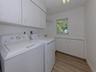The laundry room is large and offers plenty of extra storage