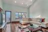 Living area with a towering ceiling, recessed lighting, and hardwood / wood-style flooring