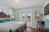 Top floor guest bedroom with balcony