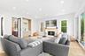 Living room featuring recessed lighting, light wood-style floors, a warm lit fireplace, and bar area