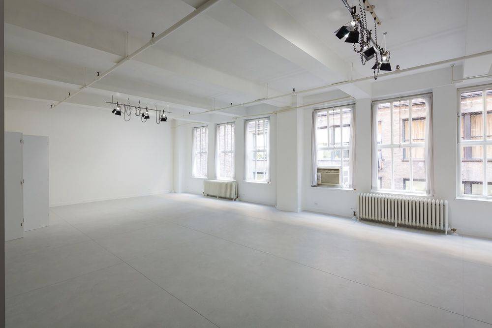 READY FOR SPRING An open 1100' loft painted white with walls of north windows, concrete floors and high ceilings.