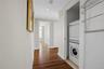 Hallway featuring wood-finish flooring, recessed lighting, and white baseboards