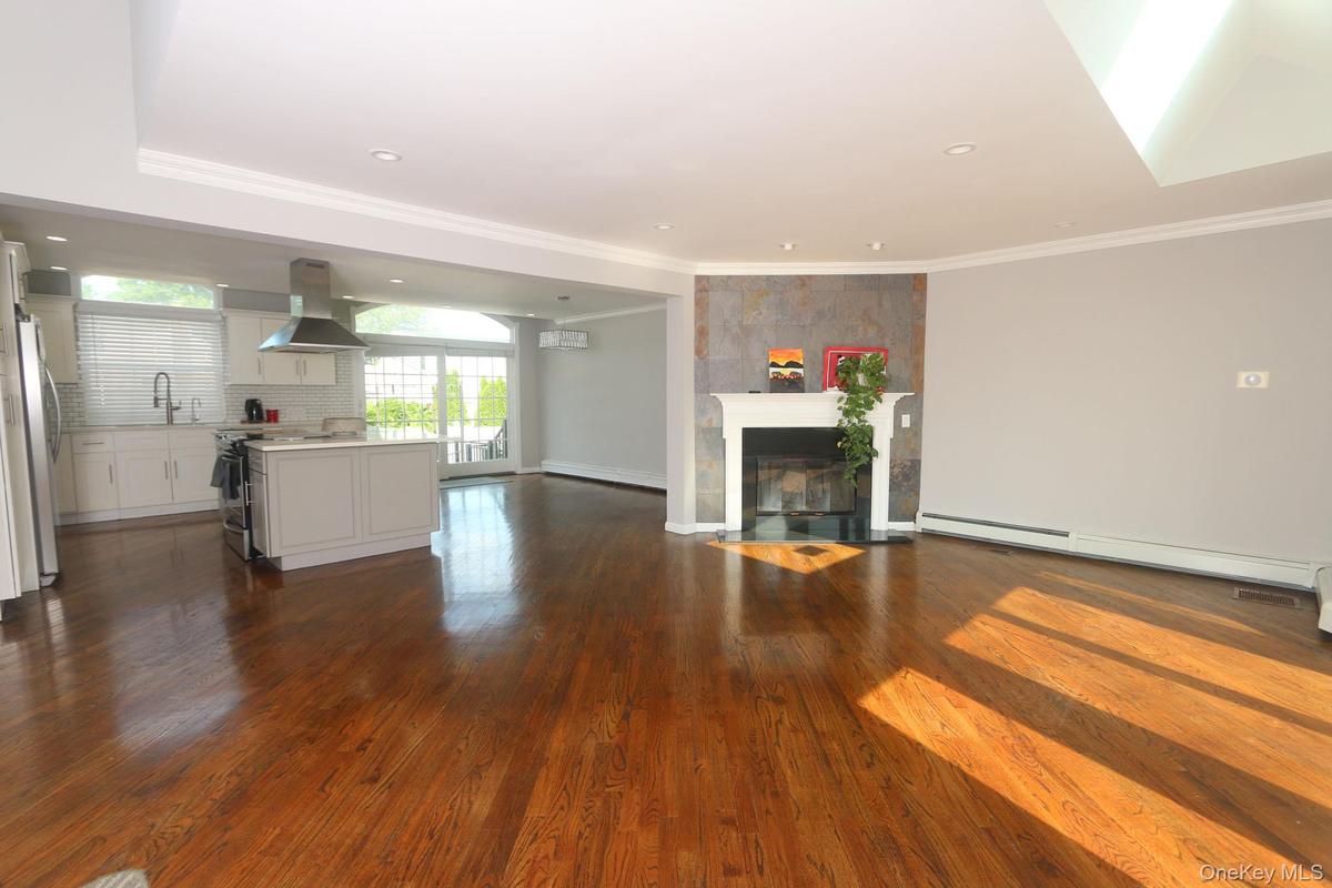 Open-concept living space with lustrous hardwood flooring throughout