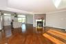 Open-concept living space with lustrous hardwood flooring throughout