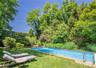 Rectangular in-ground swimming pool with a light blue interior finish and textured concrete coping