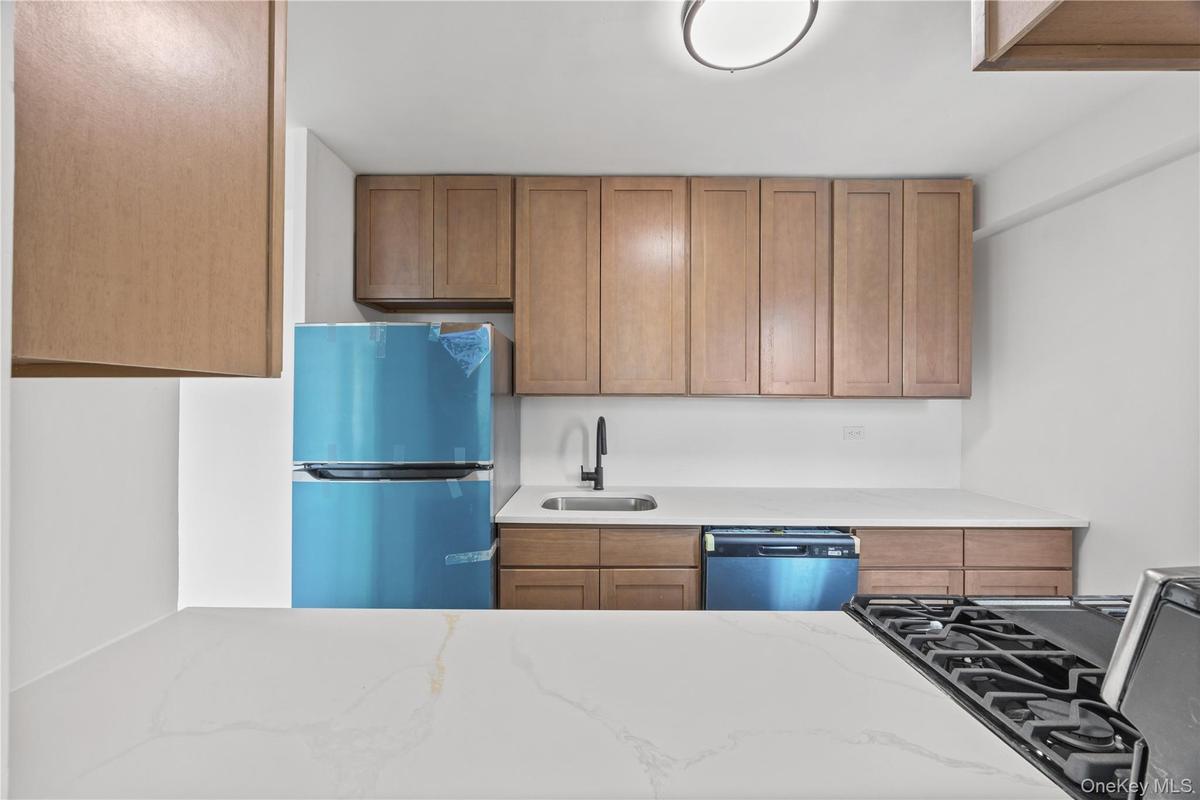 New cabinetry featuring neutral quartz counter tops