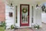 Covered side door entrance with delightful porch overlooks the side/front yard.