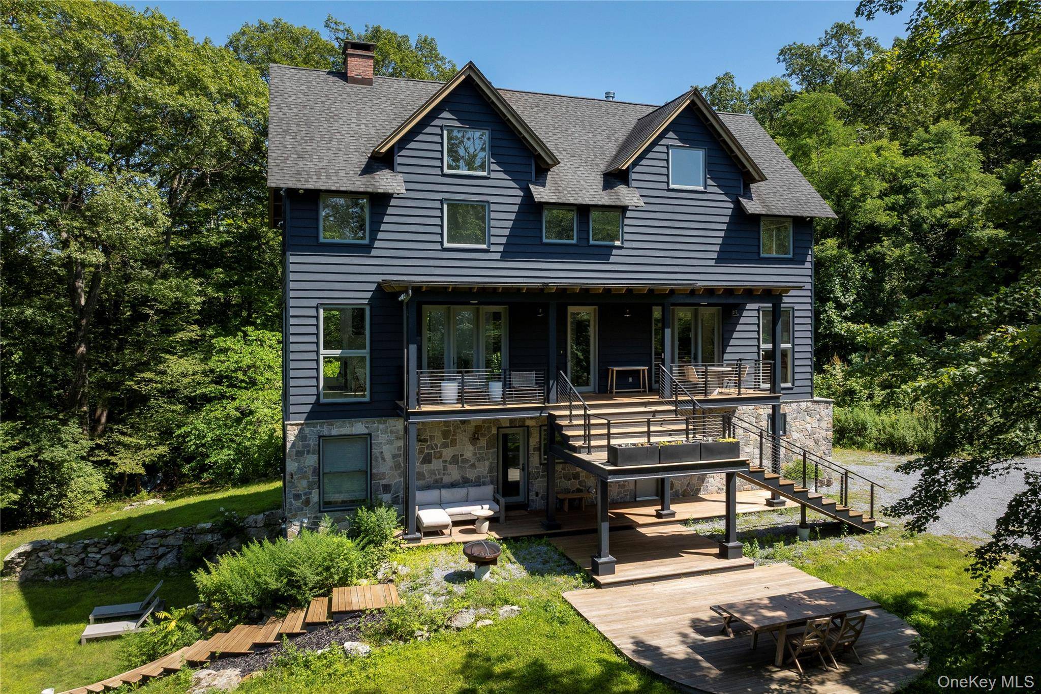 Wooded retreat meets modern comfort in this spacious Garrison home, perfectly tucked away on nearly 5 private acres !