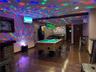Rec room featuring pool table, indoor bar, a wall mounted air conditioner, dark wood-type flooring, and a drop ceiling