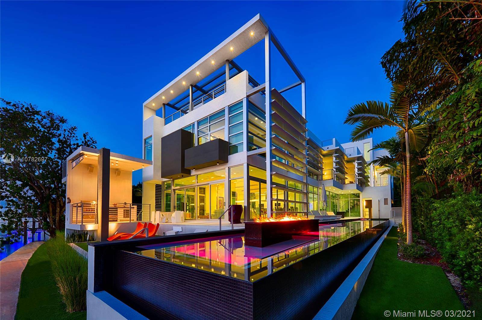 This sleek ultra modern tri level waterfront masterpiece sits on the coveted tip of guard gated Hibiscus Island.