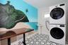Laundry room with stacked washer / dryer and tile patterned floors