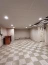 Finished below grade area featuring light flooring, a drop ceiling, and recessed lighting