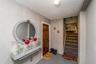 Tiled foyer with a textured ceiling and stairway