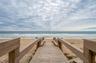 A private boardwalk leads directly from the community to the sandy shoreline, offering effortless access to the beach just steps from your door.