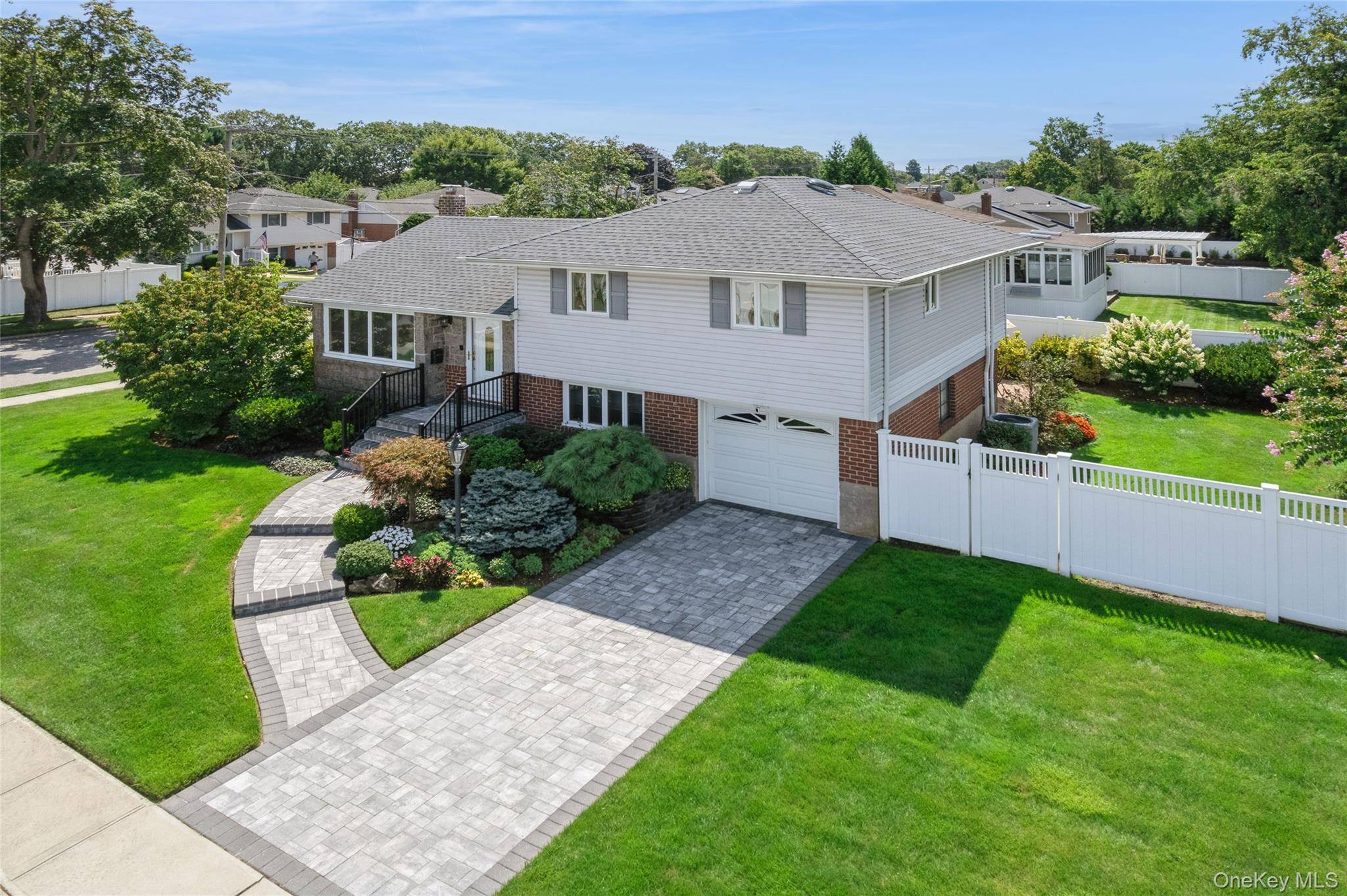 Meticulously Maintained Massapequa Park Split located on a 75x100 corner lot !