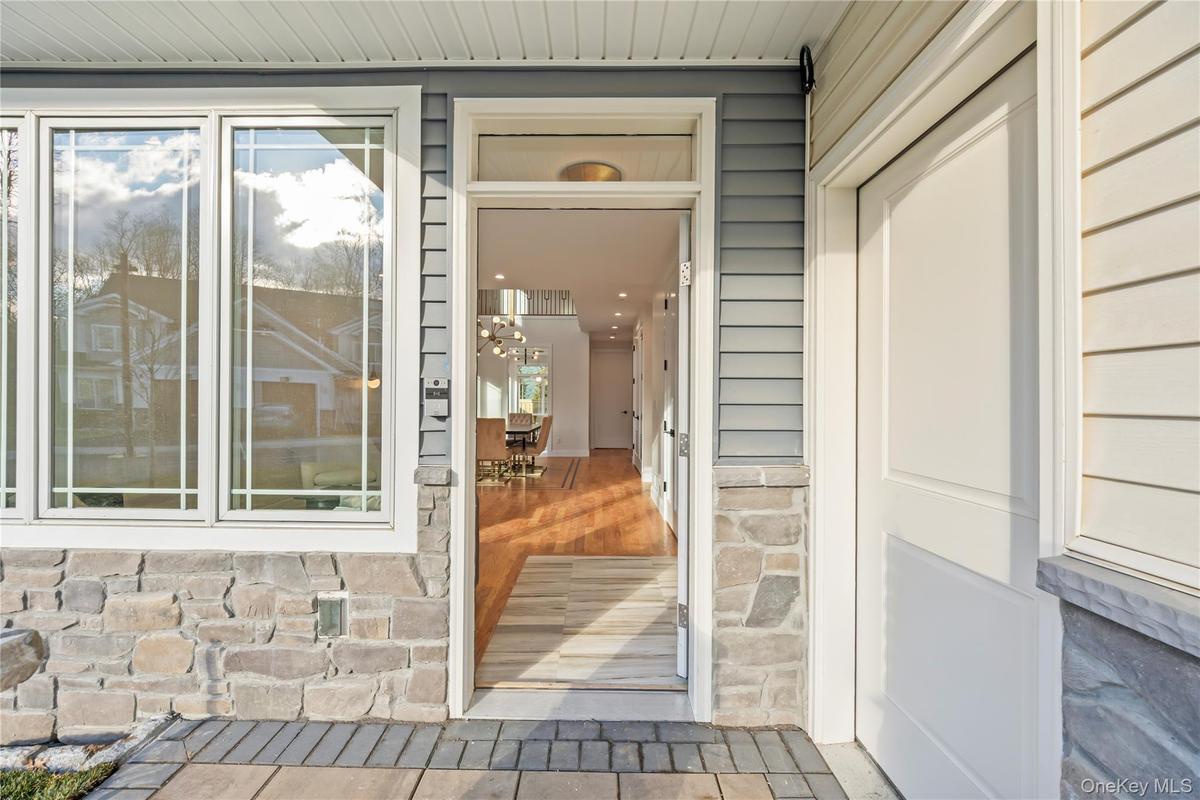 Entrance to property featuring stone siding