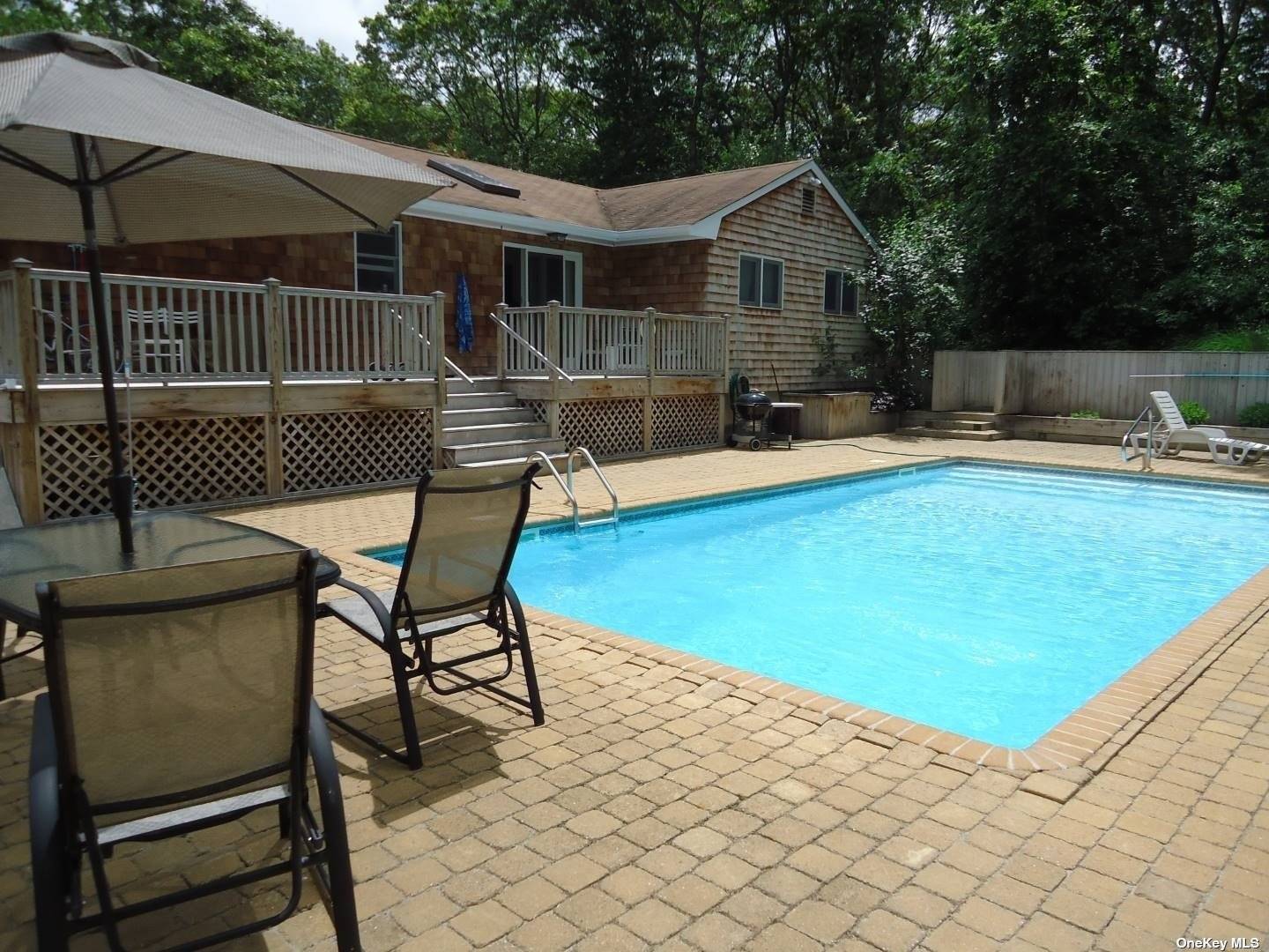 Cute 3 bedroom cape with heated pool and fully finished lower level with media rec room, full bath, and wet bar.