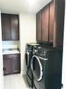 Laundry room with cabinets and deep washing sink
