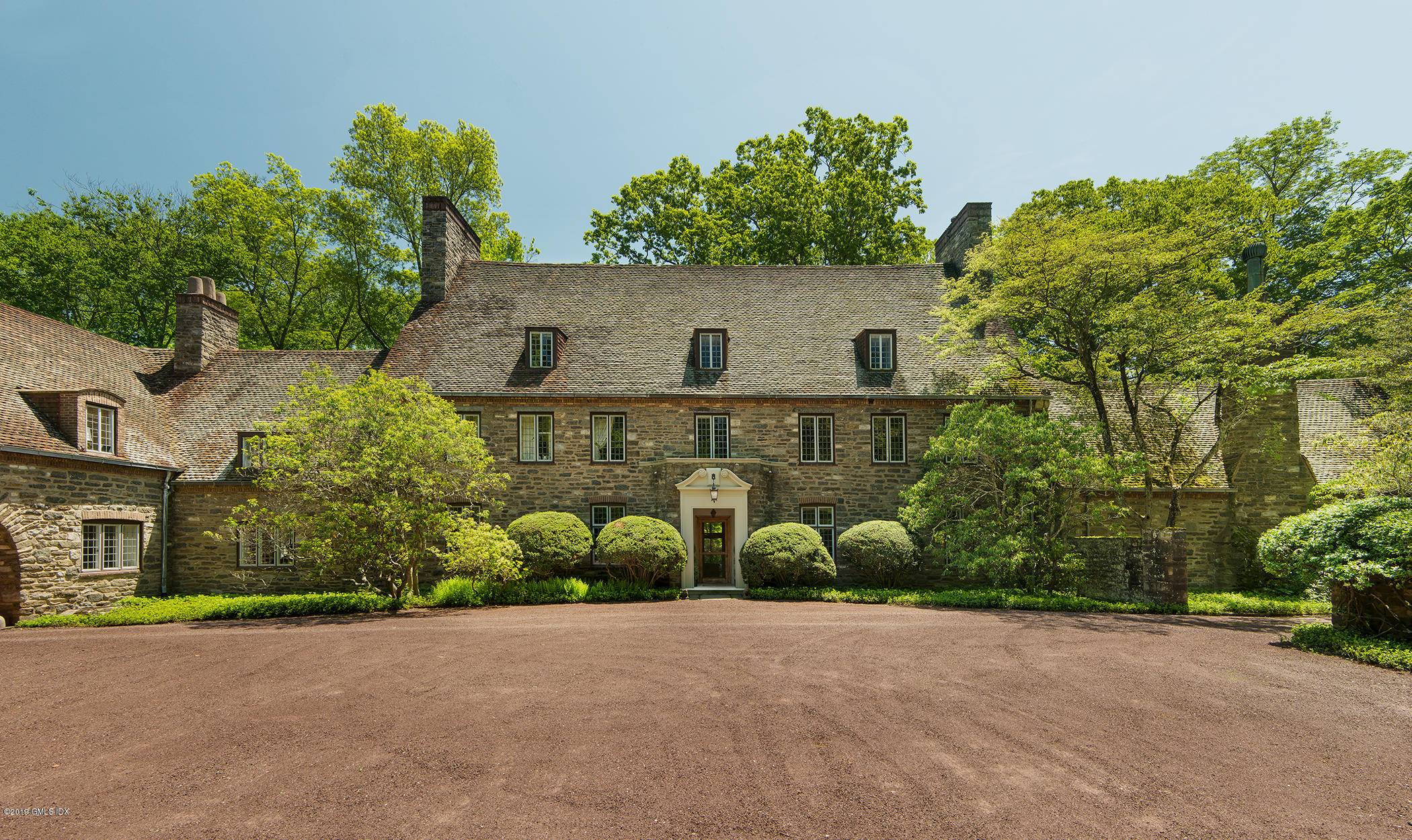 On nearly 9 acres in prime mid country Greenwich's private Khakum Wood Association, a manor home designed by the renowned American architect Harrie T.