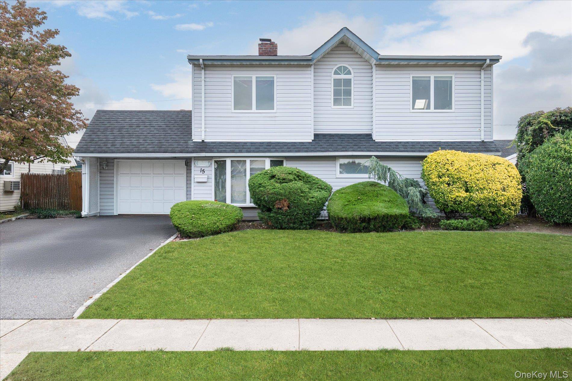 This Wantagh Colonial features a dormer and a large full rear extension.