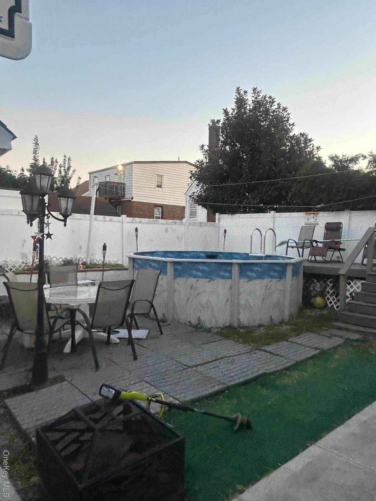 View of pool featuring a wooden deck, a patio, and outdoor dining area