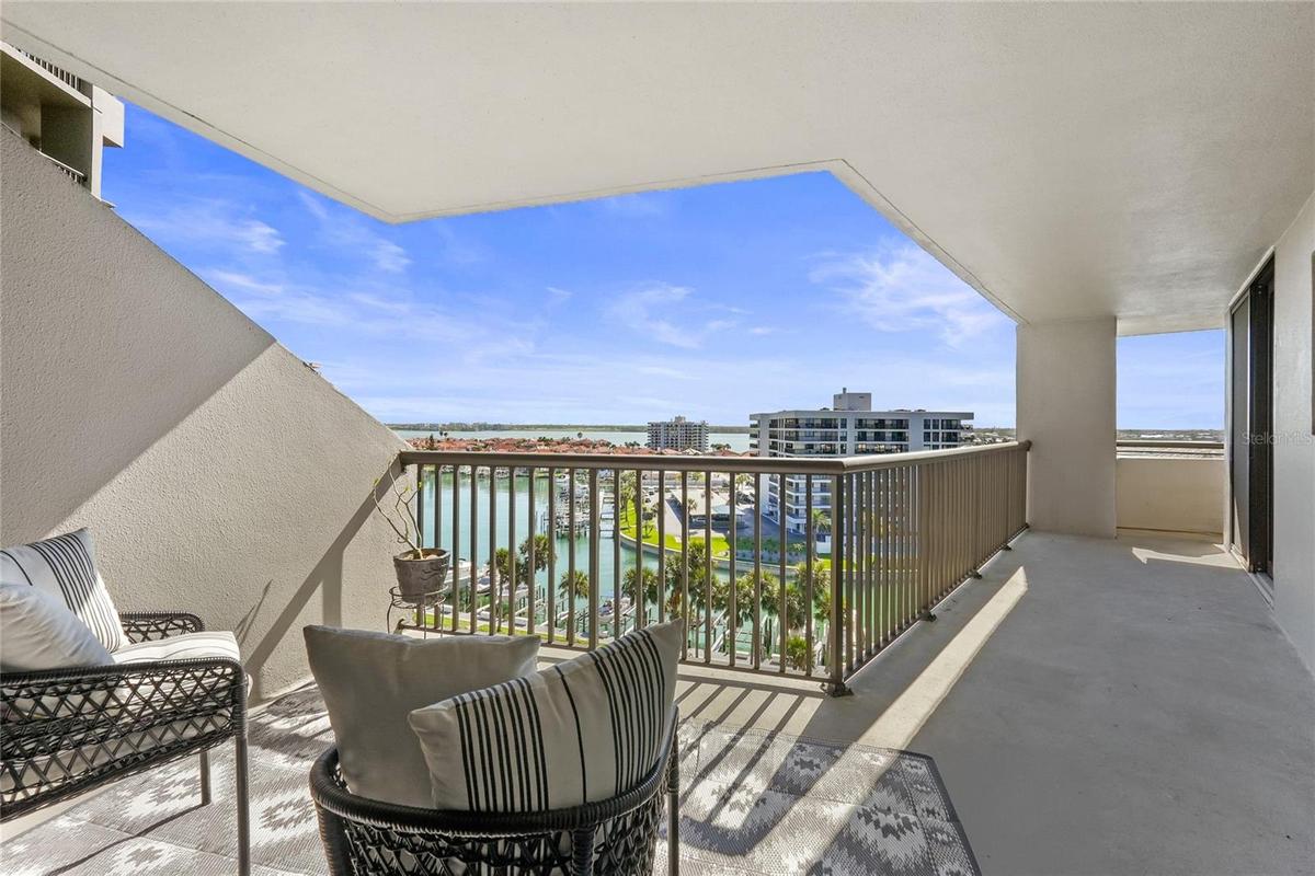 Spacious living area with sliding doors opening to the balcony and water views