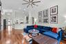 Open-concept living area with beautiful wood flooring and high ceilings.