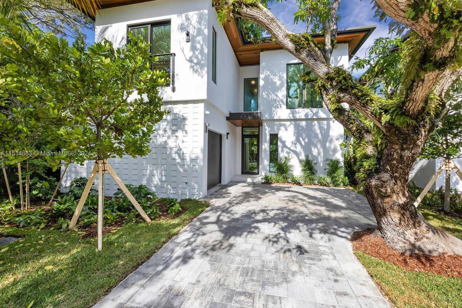 Captivating, new construction Coastal Contemporary home in prestigious North Coconut Grove.