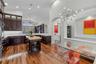 Custom kitchen with center island, rich cabinetry, and modern lighting.