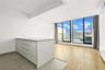 Spare room featuring an AC wall unit and expansive windows