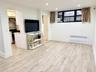 Unfurnished living room with recessed lighting, radiator heating unit, and light wood-style floors