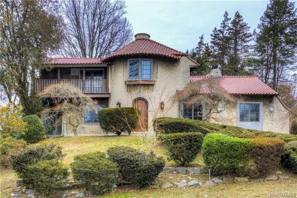 Mediterranean / spanish home featuring a balcony, stucco siding, a chimney, and a tile roof