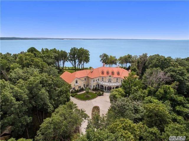 Located In The Village of Old Field, On Over 7 Acres of Panoramic Waterfront Property i acre of beachfront property on North side of Crane Neck Beach, This Luxurious Mediterranean ...