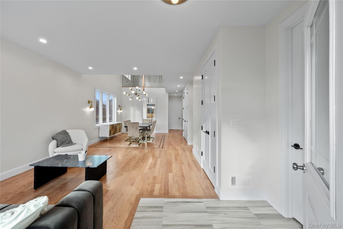 Living area featuring recessed lighting, a chandelier, and light wood finished floors