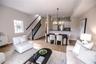 Open concept living and dining room with natural light and balcony overlooking mangroves.