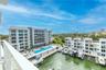 Look southeast for a view of the 25 meter lap pool with hot tub, outdoor fire table, BBQ and dining areas, outdoor putting green, and the full service