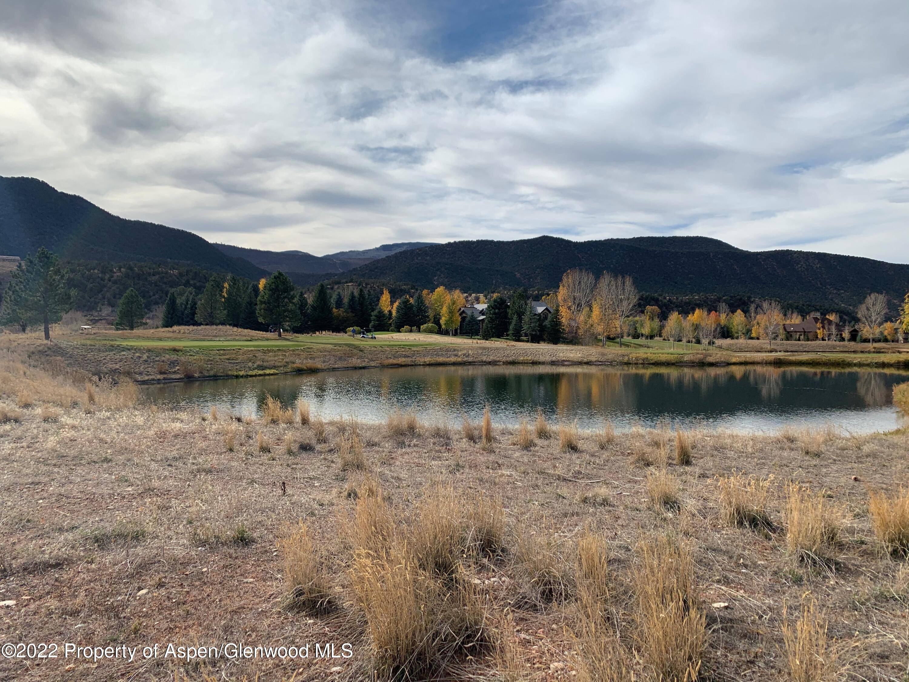Tranquil flat homesite adjacent to the pond on the 16th tee box of Aspen Glen.