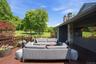 Large deck off main floor of primary home with views of stream and pond