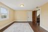 Empty room featuring baseboards and dark wood-style flooring