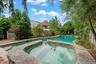View of pool with a patio area and a pool with connected hot tub