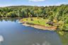 Bird's eye view of a nearby body of water and a heavily wooded area