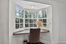 PRIMARY BEDROOM: This sunny Bay window offers a built-in desktop. Just bring your laptop, journal, morning to-do list and don't forget your morning co