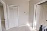 Quaint landing leading to primary bedroom